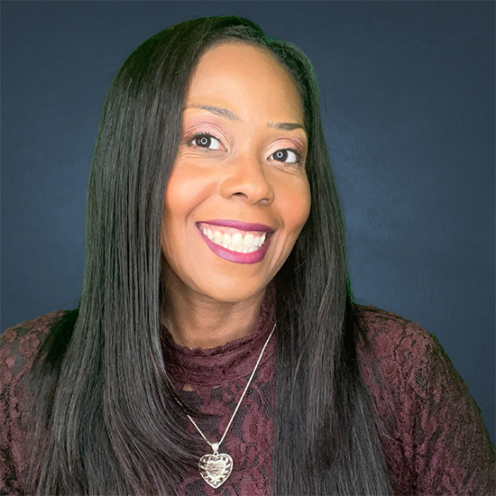 Headshot of a woman with long black hair and a big smile